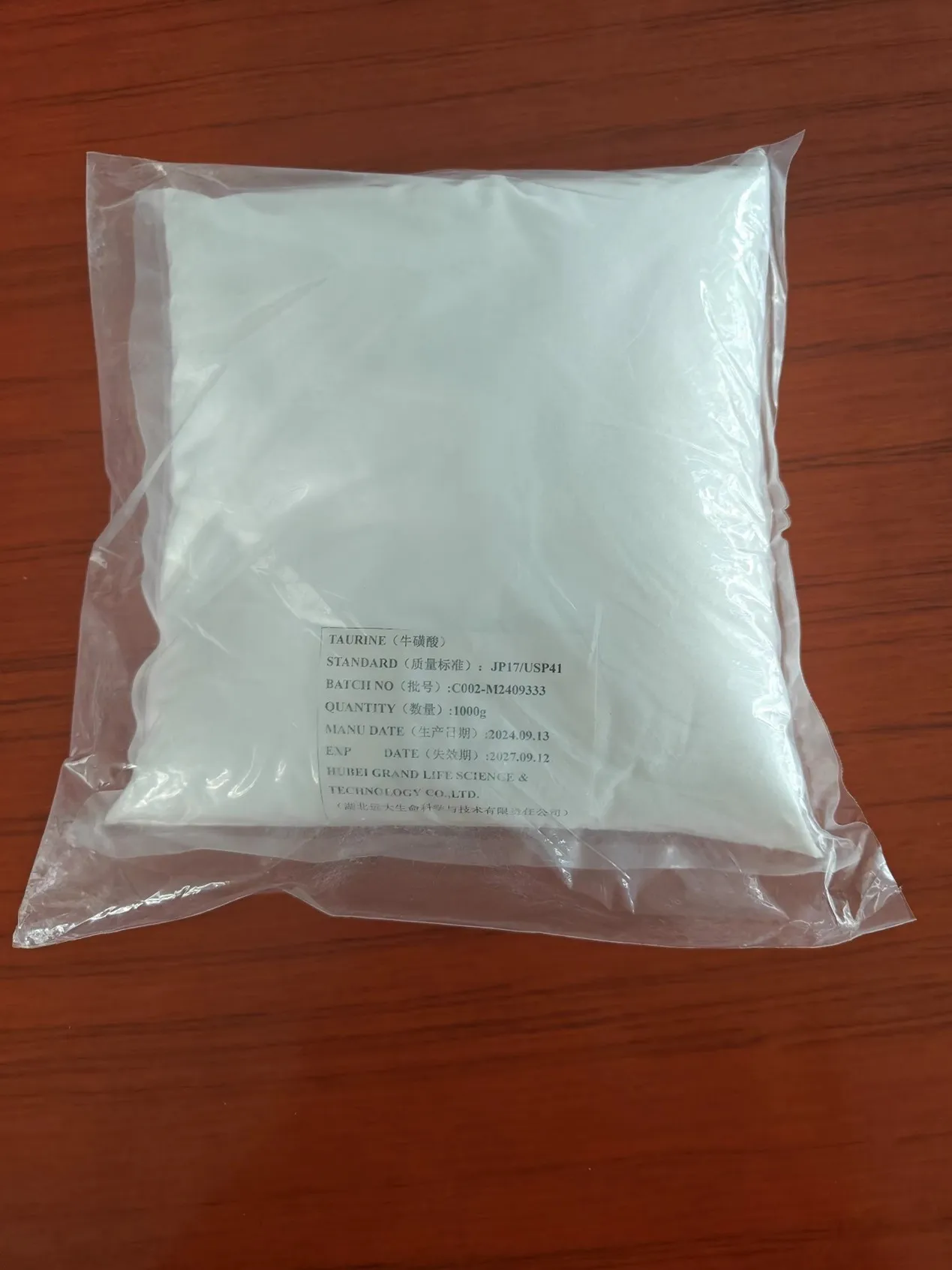 Taurine 99.0–101.0% white crystalline powder in 1 kg inner bag sample