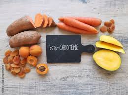 Beta-carotene ingredient concept with naturally orange carotenoid-rich food sources.