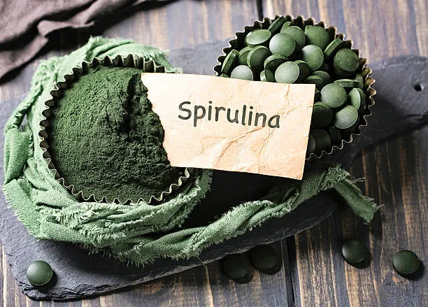Spirulina Powder 60% Protein dark-green algae powder and tablets for vegan nutrition products.