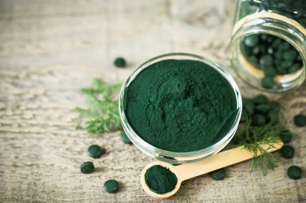 Bulk Spirulina Powder 60% Protein in dark-green fine powder form for food and supplement formulations.